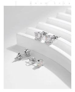 Close-up of S925 sterling silver moissanite stud earrings with classic four-prong setting