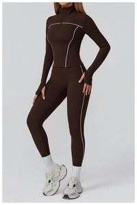 Detail of slim-fit chocolate yoga jacket featuring contrast white stitching and thumbholes