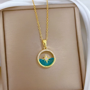 Close-up of golden necklace featuring an octagonal star pendant with diamonds and blue enamel