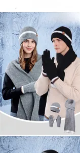 Detailed view of women's knitted hat, scarf, and touch-screen gloves set in snowy outdoor
