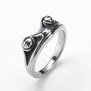 Macro shot of vintage silver frog ring showing detailed metallic texture and antique finish