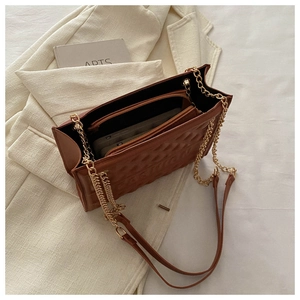 Top view of brown quilted bag interior with main compartment and golden chain strap