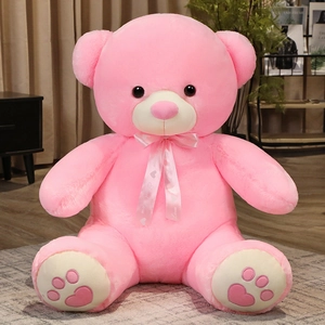 Detail showing soft pink plush teddy bear with Sweet Love ribbon and heart paw prints