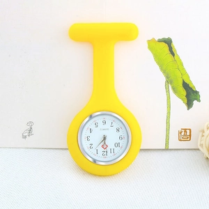 Close-up of yellow silicone nurse pocket watch with quartz movement on floral background