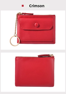 Close-up of crimson mini coin purse with gold keychain and textured leather finish
