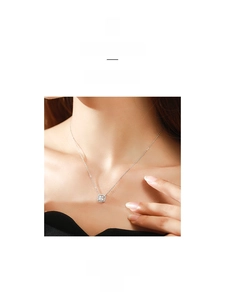 Macro detail of silver S925 necklace with square halo pendant and cubic zirconia