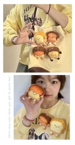 Detailed view of mini plush toast pendants with various cute facial expressions on a bag
