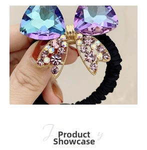 Detail of crystal butterfly hair tie with gradient purple wings and black elastic band