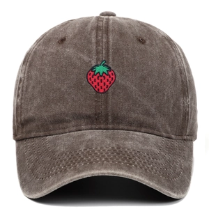 Detailed embroidery of a small strawberry on a vintage washed cotton baseball cap