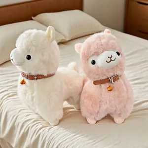 Cute plush alpaca stuffed animals in white and pink with decorative bell collars