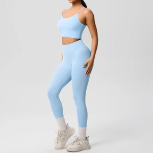 Detail of light blue two-piece yoga set including a strappy sports bra and high-waist leggings