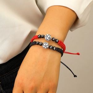 Detail of adjustable 2026 World Cup football hand-woven bracelets on model wrist