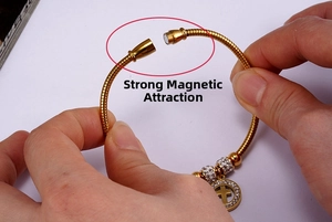 Detail showing the strong magnetic clasp on a gold stainless steel cross bracelet