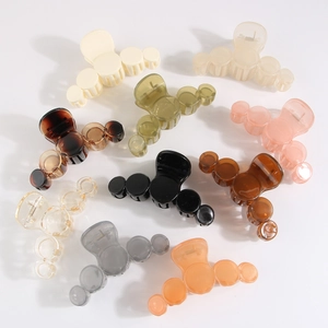 Flat lay of multiple colorful PS material claw clips shown from various angles on white background