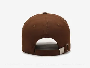 Detail view of the brown baseball cap back with adjustable silver metal buckle strap