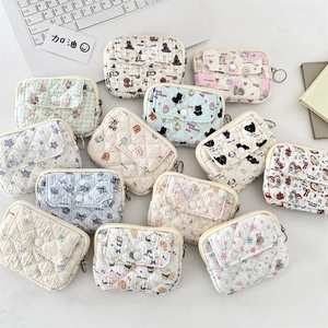 Close-up of quilted card holders featuring cute animal prints and secure metal hooks