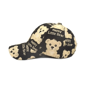 Black baseball cap featuring beige Happy Little Bear print and cartoon motifs
