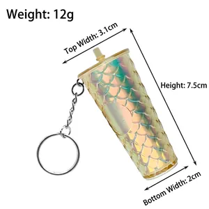 Mini iridescent gold tumbler keychain with dimensions 7.5cm height and scale details