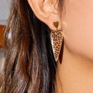 Vintage leopard print heart dangle earrings in gold finish worn by a model