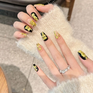 Luxury black cat-eye press-on nails with golden geometric foil and zircon accents
