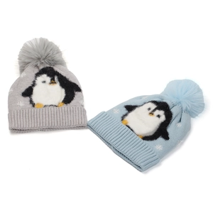 Detail of penguin jacquard knit beanie featuring fluffy faux fur pompom and soft rib cuff