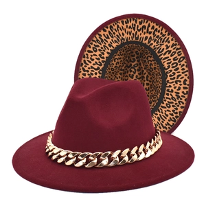 Detail of wine red wool fedora featuring gold cuban chain and leopard print lining