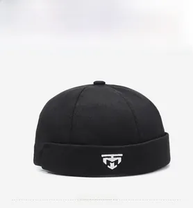 Detailed front view of black miki hat with white geometric embroidery on high quality fabric