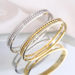 Luxurious gold and silver titanium steel bangles with double-row rhinestones and gear motifs