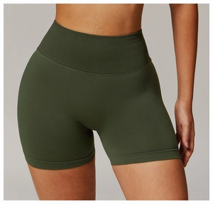 Detail of high-waist ribbed waistband on seamless dark green compression yoga shorts