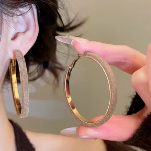 Minimalist geometric round hoop earrings with brown velvet flocking and gold finish