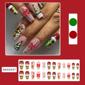 Detail of Christmas press-on nails with 3D red bows, snowflakes and glitter patterns