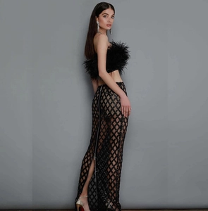 Two-piece black set featuring ostrich feather bandeau top and sequin mesh long skirt
