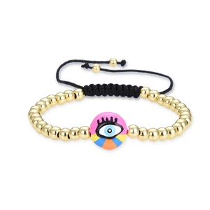 Handwoven evil eye bead bracelet with gold copper beads and colorful enamel accents
