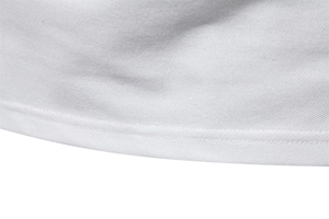 Close-up of white pique knit fabric texture and high-quality hem stitching on the polo shirt