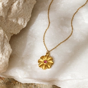 Gold plated stainless steel necklace with pink zircon flower pendant on white stone