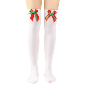 Detail of white over-the-knee Christmas socks with red and green ribbon bow decoration