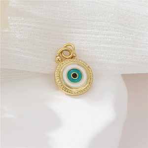 Detailed shot of a gold sun and moon evil eye pendant with micro-set zircon and enamel