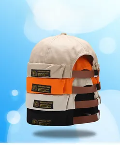 Stack of retro canvas miki hats in beige, orange, grey, and black with leather straps