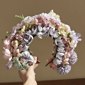 Ethnic style floral headband with purple and pink faux flowers and green leaves decoration