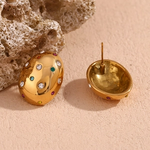 Macro view of 18K gold plated oval stud earrings with colorful zircon gemstones