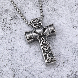 Macro detail of stainless steel Claddagh cross necklace with Celtic knot patterns