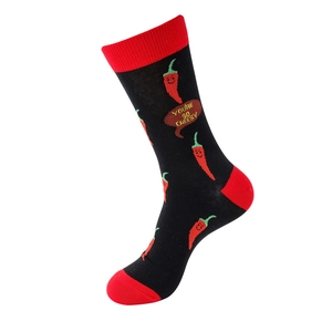 Detail of black cotton sock with red accents and 'YOU'RE SO CHEESY' chili pattern