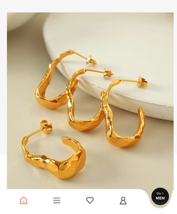 Macro view of 18K gold stainless steel earrings with organic molten ripple design
