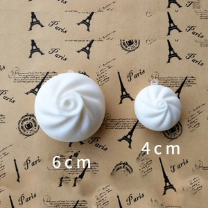 6cm and 4cm soft white spiral steamed bun slow rebound toys on vintage background