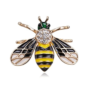 Macro detail of bee brooch featuring sparkling rhinestones and colorful enamel work