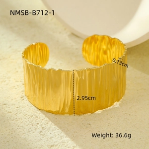 Detail of wide gold cuff bracelet with ripple texture showing 2.95cm height and dimensions