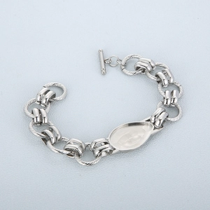 Detail of silver stainless steel chain bracelet with OT toggle clasp and droplet bezel