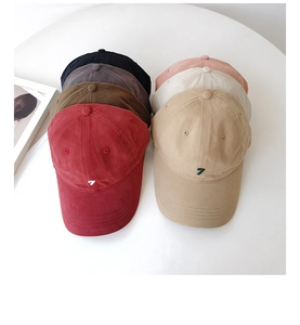 Flat lay of multiple washed baseball caps in six colors with embroidered number 7