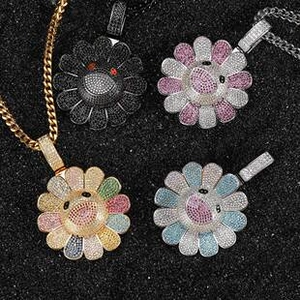 Macro shot of assorted colorful diamond-set sunflower pendants on dark glitter background