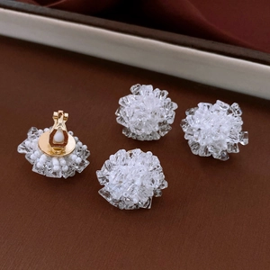 Macro detail of crystal floral clip-on earrings with gold finish and silicone pads